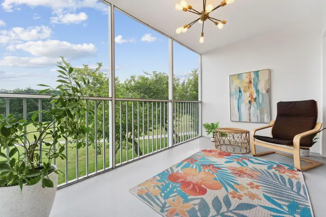 a balcony with furniture and a potted plant