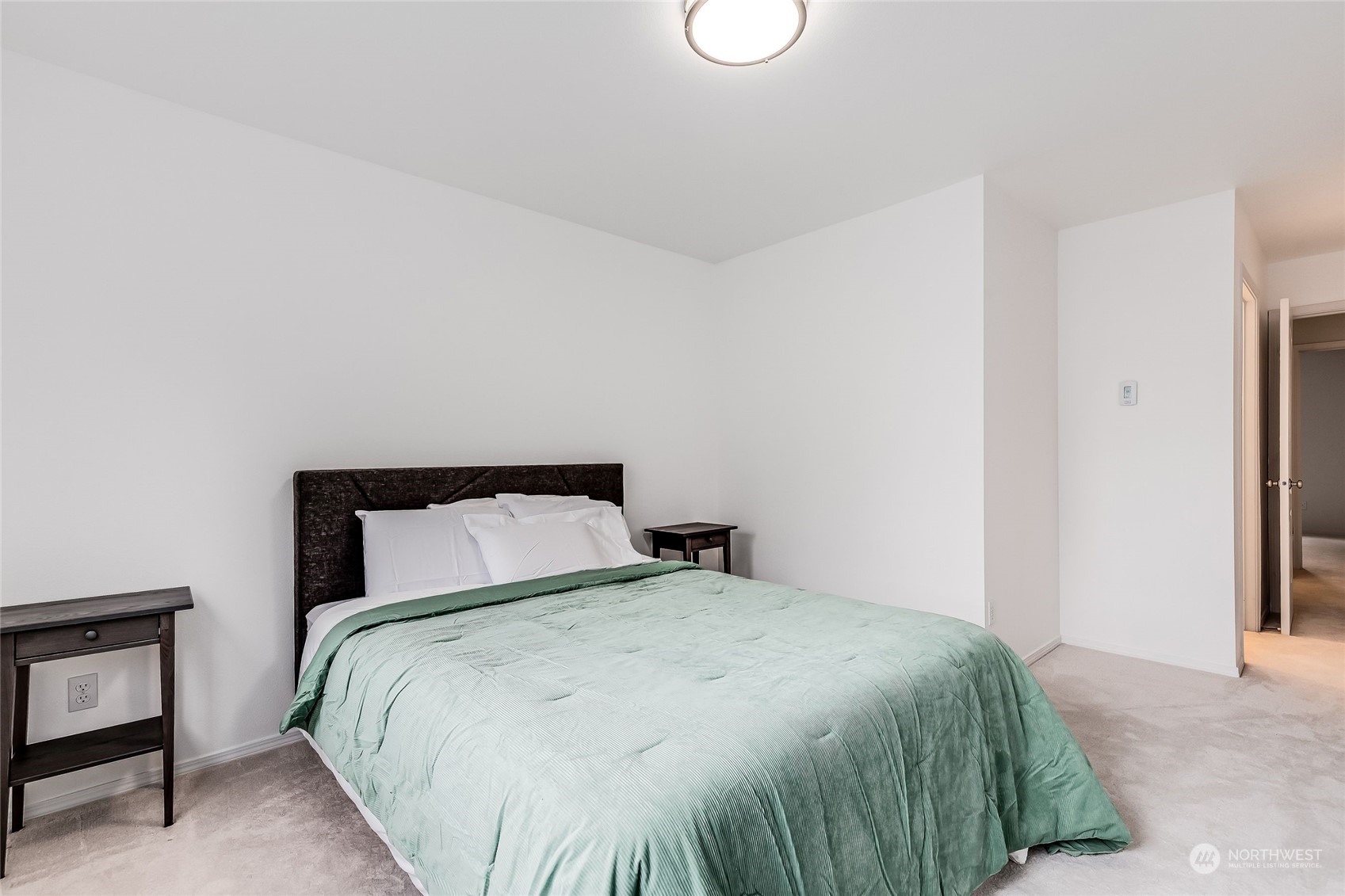 10030 Holly Drive, Unit 122 Everett, WA 98204 - Photo 17 of 29 a bedroom with a bed and a window