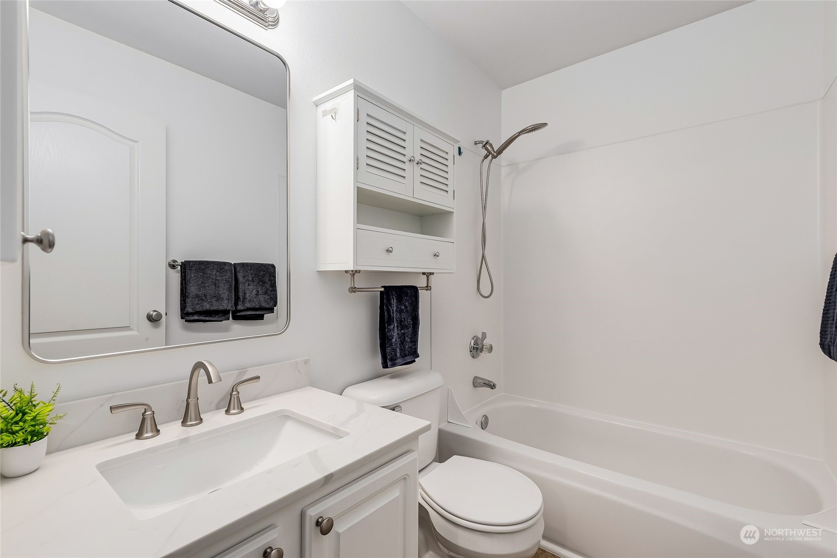 10030 Holly Drive, Unit 122 Everett, WA 98204 - Photo 22 of 29 a bathroom with a sink toilet a mirror and shower