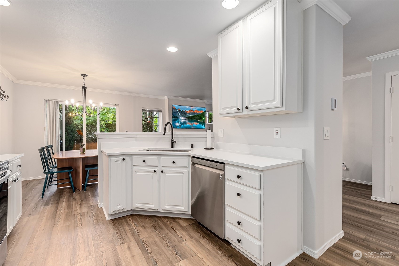 10030 Holly Drive, Unit 122 Everett, WA 98204 - Photo 9 of 29 a kitchen with white cabinets and wooden floors