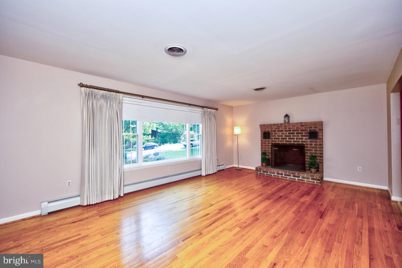 8701 Inwood Road Baltimore, MD 21244 - Photo 4 of 34 Large brick screened fireplace w/ heatilator