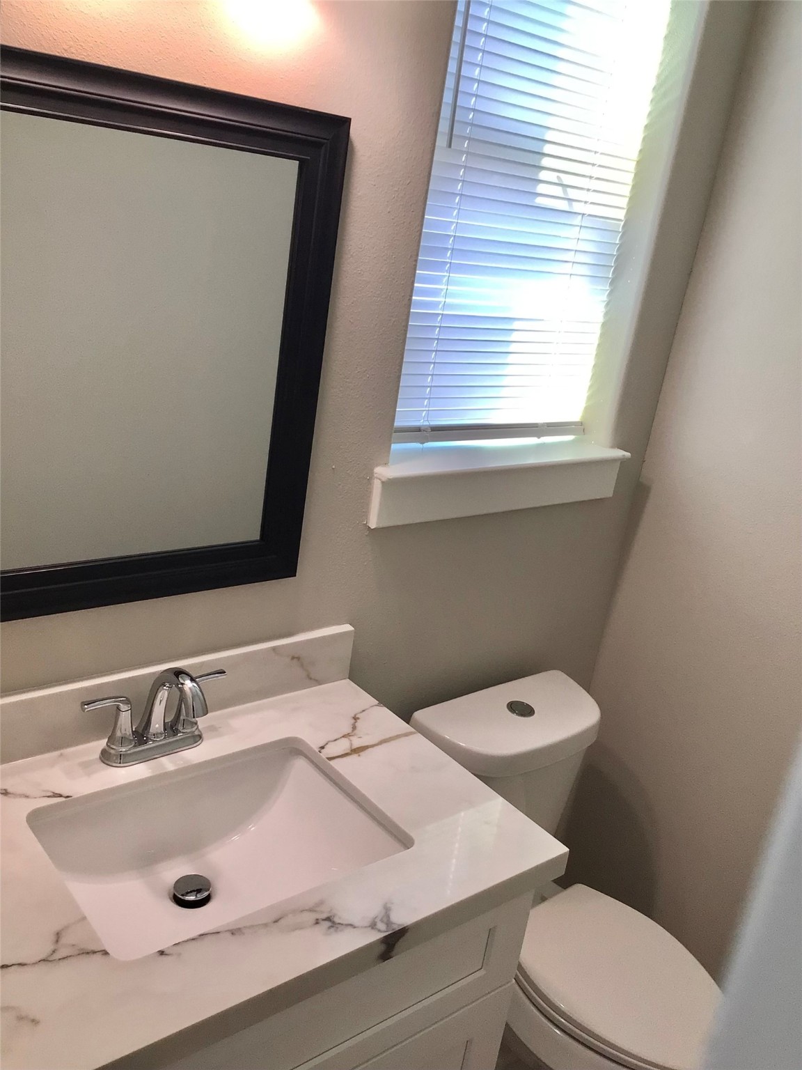 2109 Marnel Road, Unit C Houston, TX 77055 - Photo 16 of 27 a bathroom with a sink a toilet a mirror and window