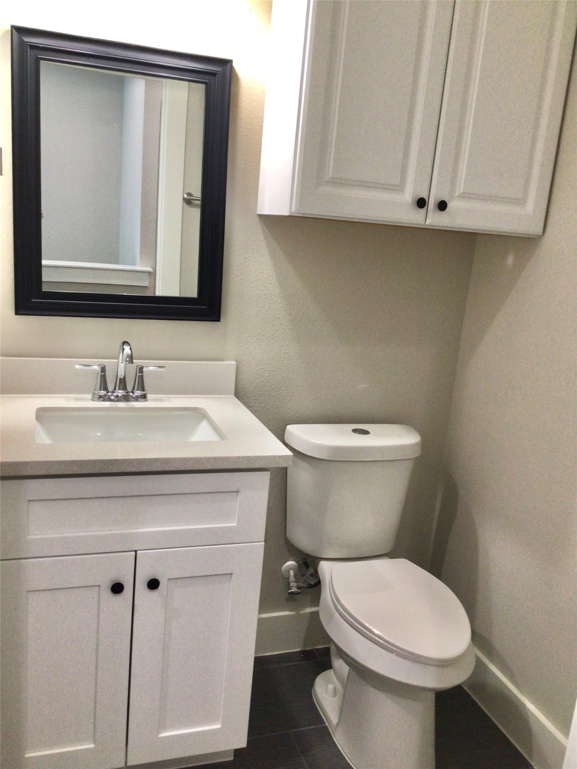2109 Marnel Road, Unit C Houston, TX 77055 - Photo 17 of 27 a bathroom with a toilet a sink and mirror