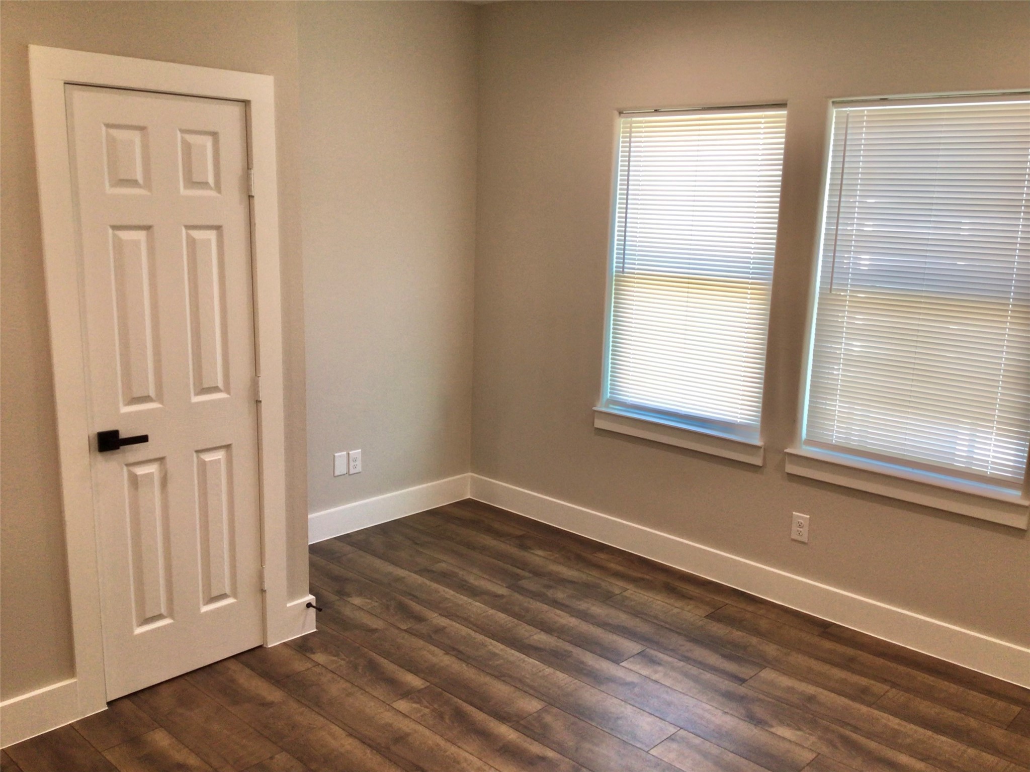 2109 Marnel Road, Unit C Houston, TX 77055 - Photo 19 of 27 an empty room with wooden floor and windows