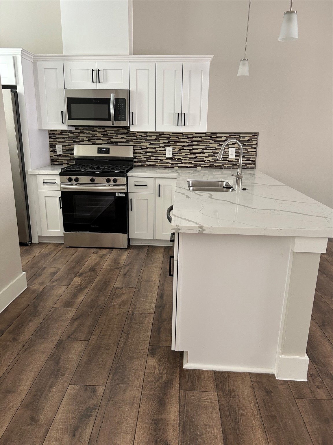 2109 Marnel Road, Unit C Houston, TX 77055 - Photo 8 of 27 a kitchen with stainless steel appliances granite countertop a stove a sink and a microwave