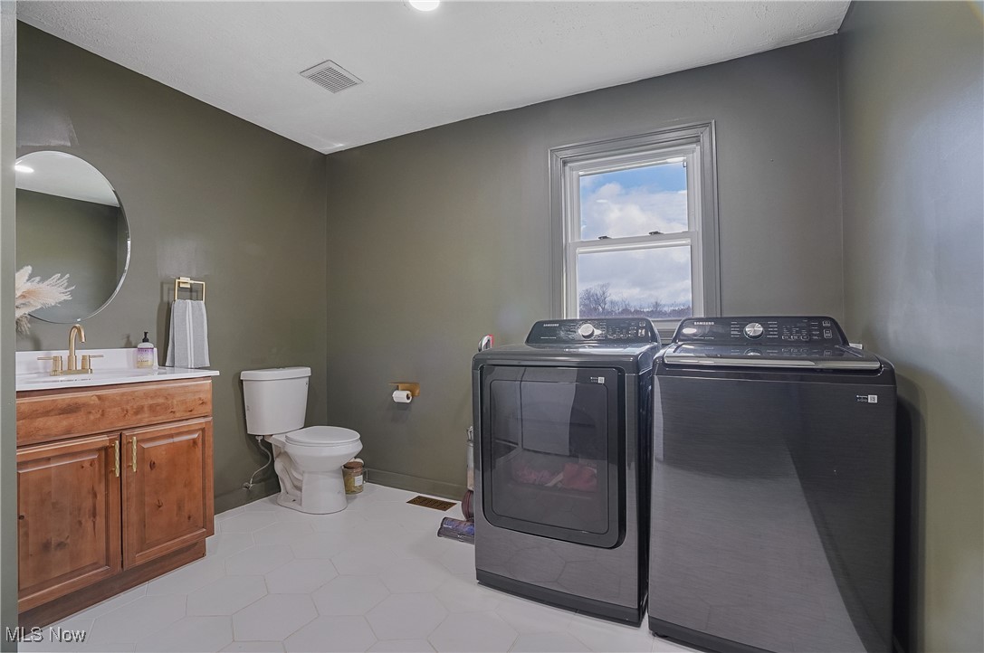 9278 Bryant Road Windham, OH 44288 - Photo 3 of 47 Washroom featuring light tile patterned floors and washing machine and clothes dryer