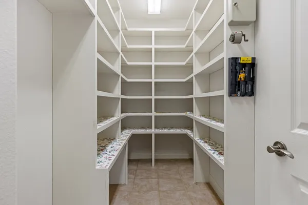 a view of walk in closet with empty racks