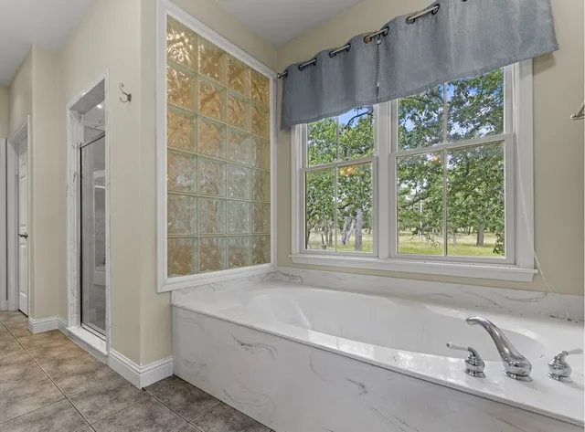 a bath tub sitting in a bathroom next to a window