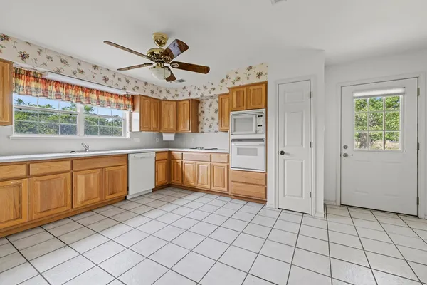 a kitchen with a sink a stove cabinets and stainless steel appliances
