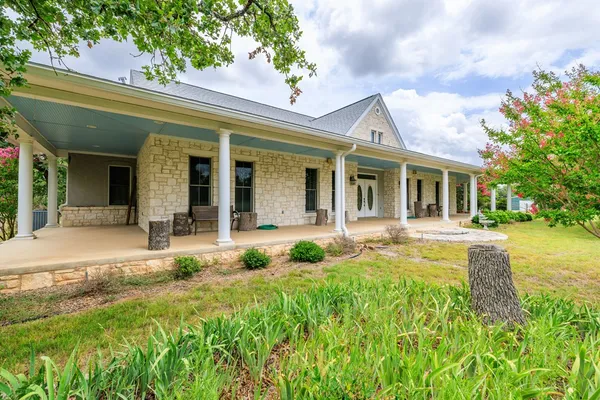 a front view of a house with swimming pool and porch
