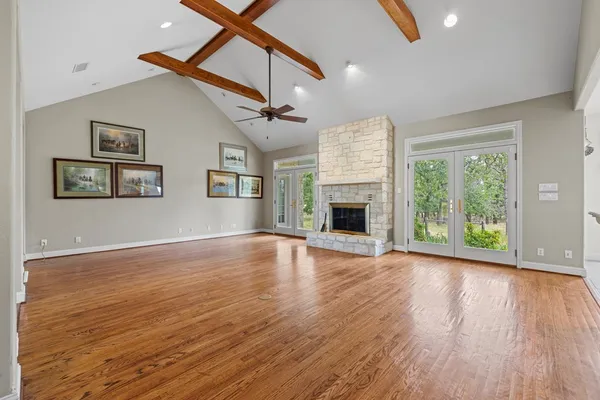 a view of empty room with wooden floor and fireplace