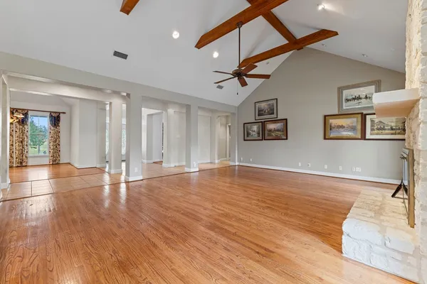 a view of a livingroom with wooden floor and white walls