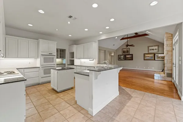 a kitchen with counter top space cabinets and stainless steel appliances