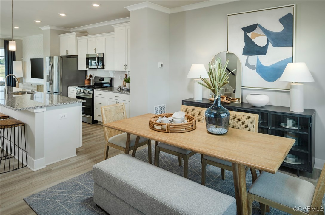 16017 Abelson Way Chesterfield, VA 23832 - Photo 6 of 21 a kitchen with a dining table chairs and refrigerator