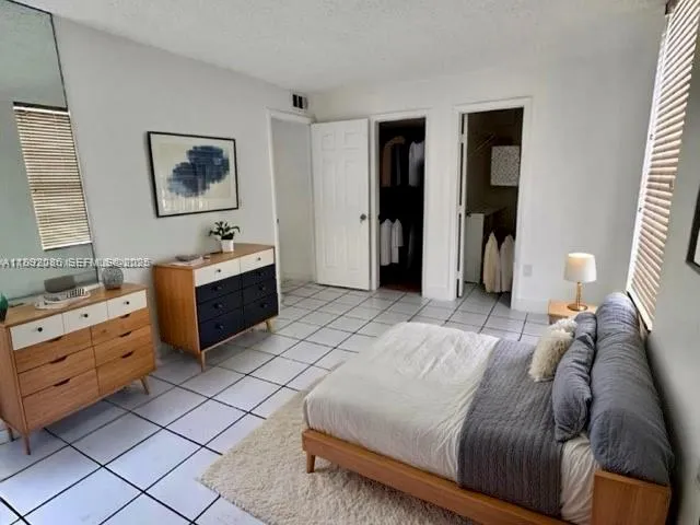 a bedroom with a bed and a table in it