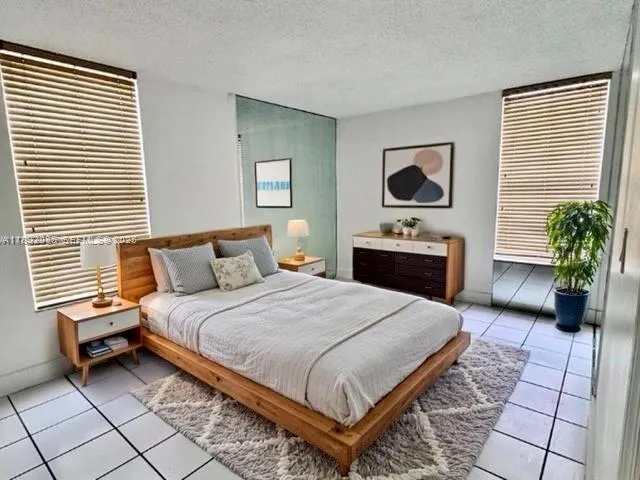 a bedroom with a bed and a potted plant