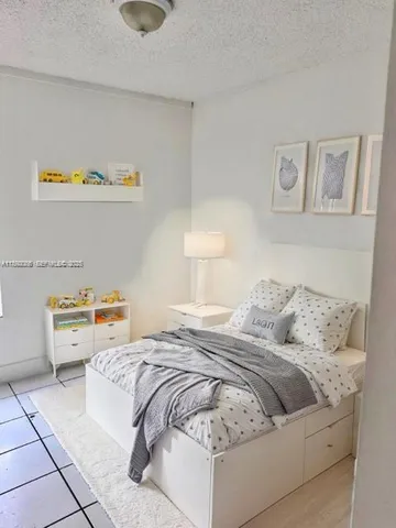 a bedroom with a bed and couch