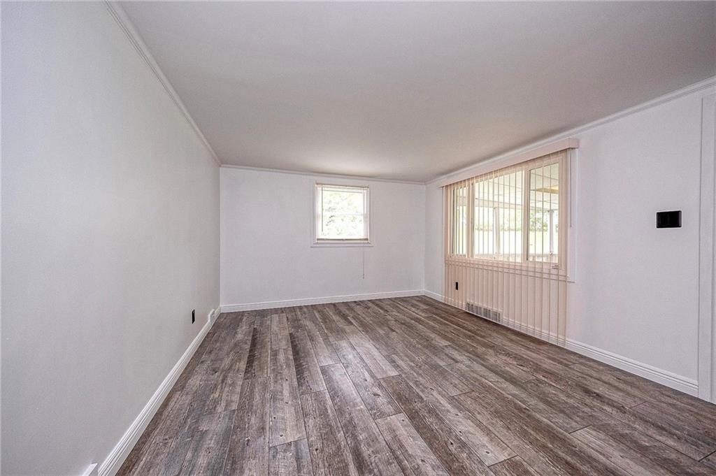 531 Laughlin Avenue Pittsburgh, PA 15210 - Photo 7 of 35 a view of an empty room with wooden floor and window