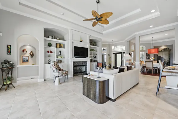 a dining room with wooden floor a chandelier a wooden table and chairs