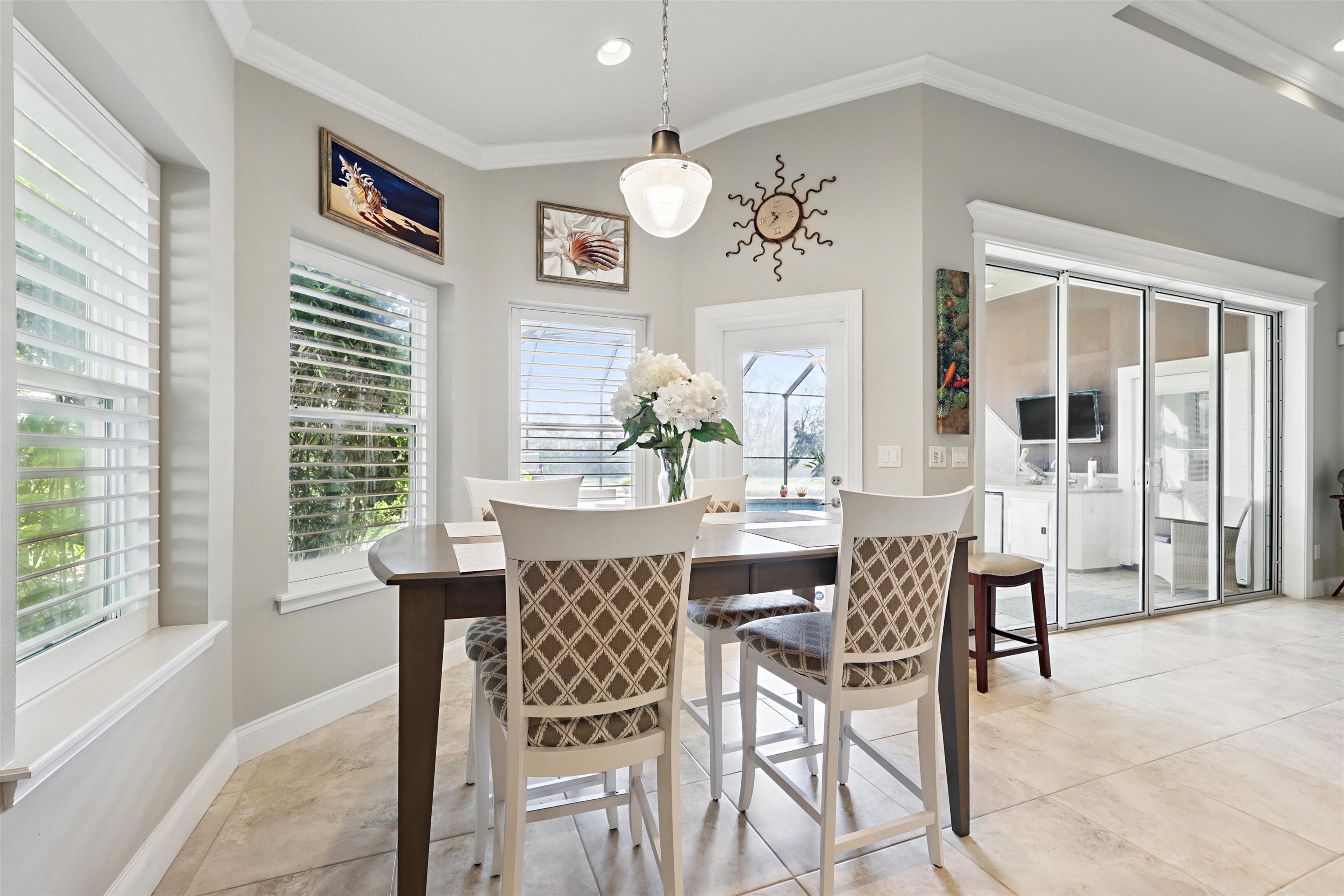 322 Fiddlers Point Drive St. Augustine, FL 32080 - Photo 13 of 58 a dining room with wooden floor a chandelier a wooden table and chairs