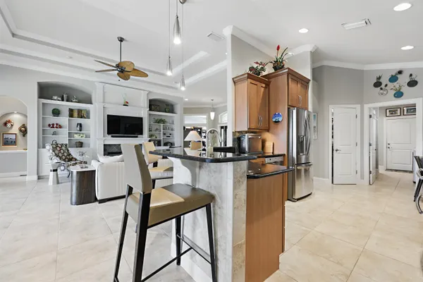 a kitchen with stainless steel appliances granite countertop a refrigerator and a stove top oven
