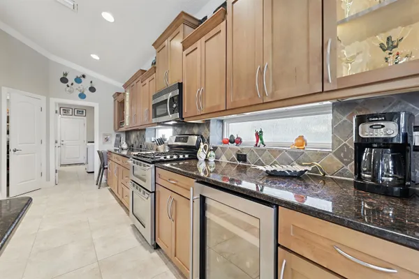 a kitchen with stainless steel appliances granite countertop a stove microwave and cabinets