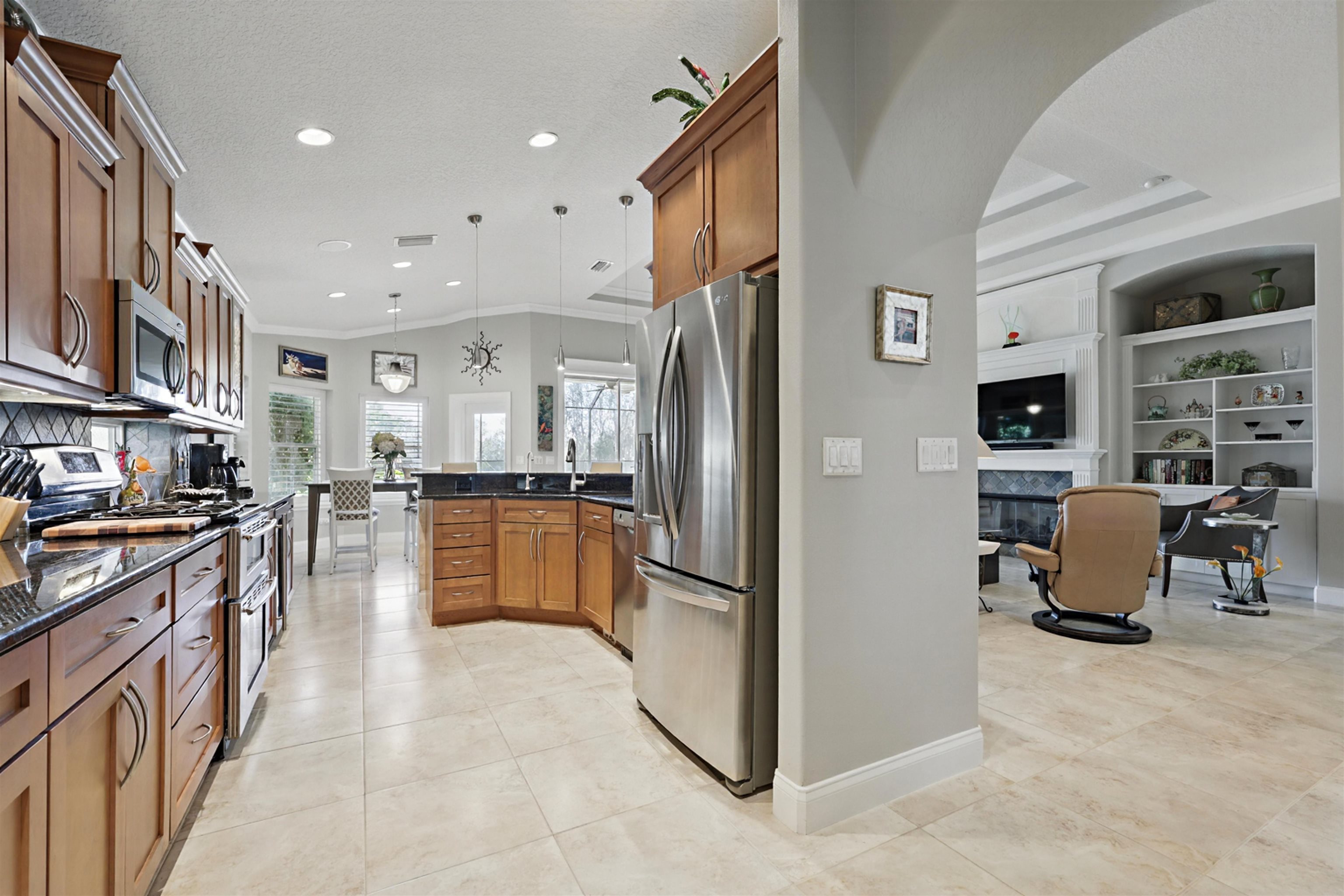 322 Fiddlers Point Drive St. Augustine, FL 32080 - Photo 16 of 58 a kitchen with stainless steel appliances granite countertop a refrigerator and a stove top oven