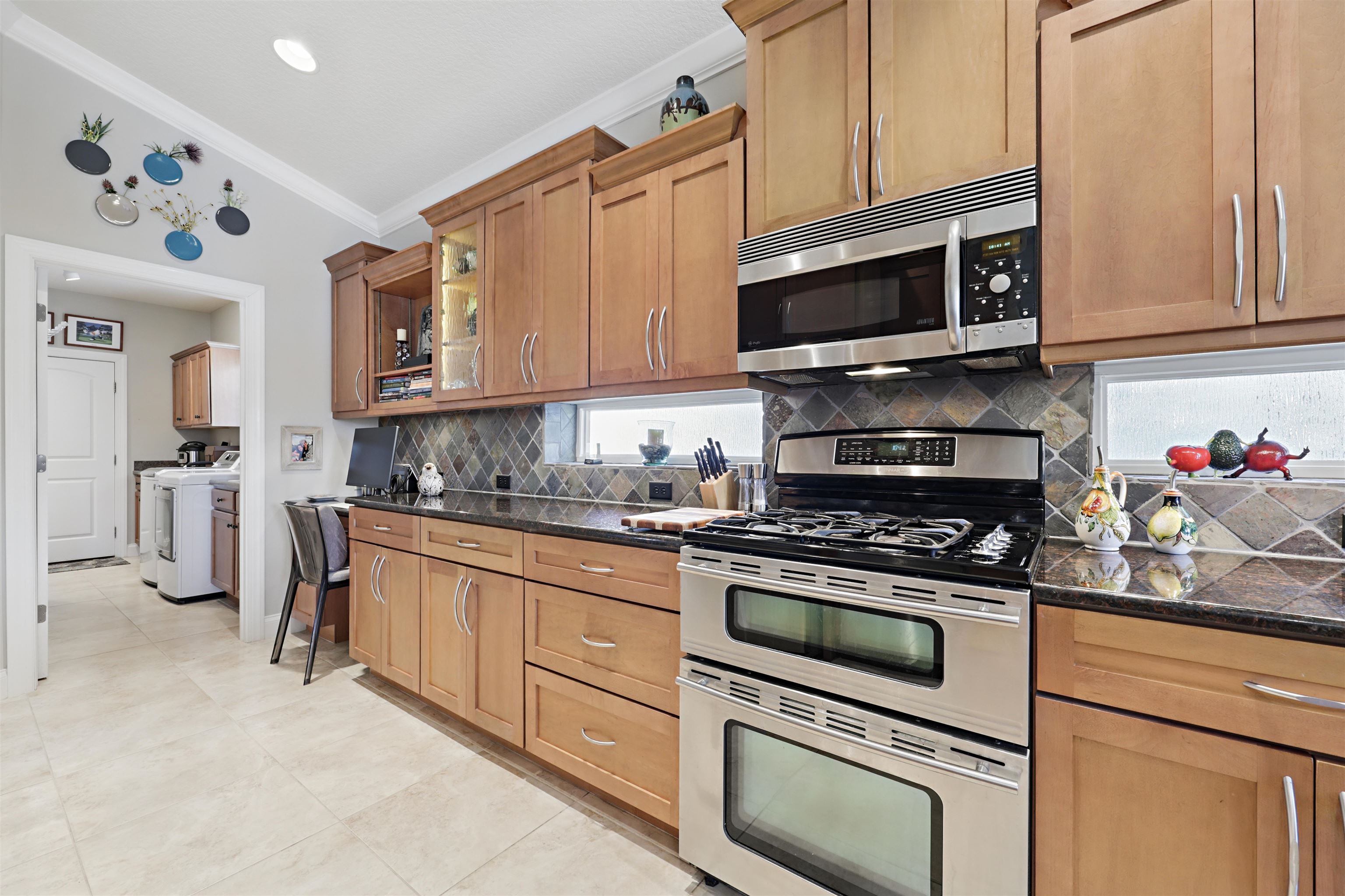 322 Fiddlers Point Drive St. Augustine, FL 32080 - Photo 18 of 58 a kitchen with stainless steel appliances granite countertop a stove microwave and cabinets