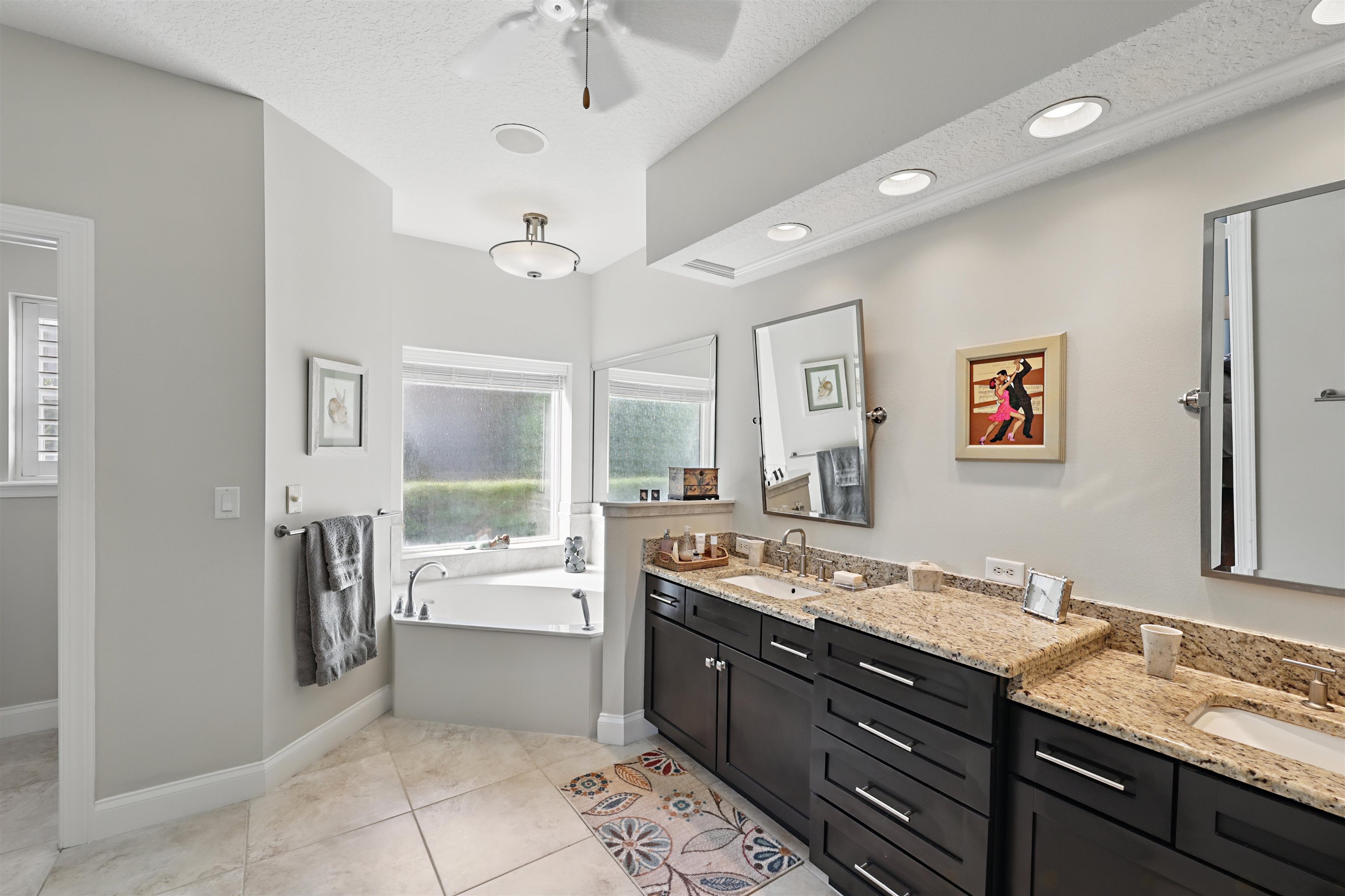 322 Fiddlers Point Drive St. Augustine, FL 32080 - Photo 26 of 58 a spacious bathroom with a granite countertop sink a toilet a mirror and shower