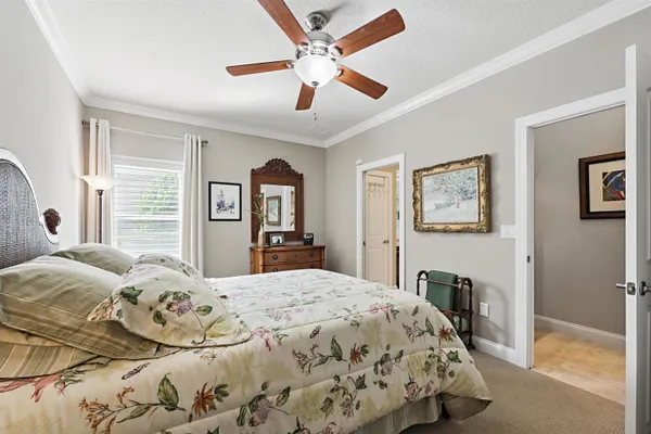 a kitchen with stainless steel appliances granite countertop a stove a sink and a refrigerator with white cabinets