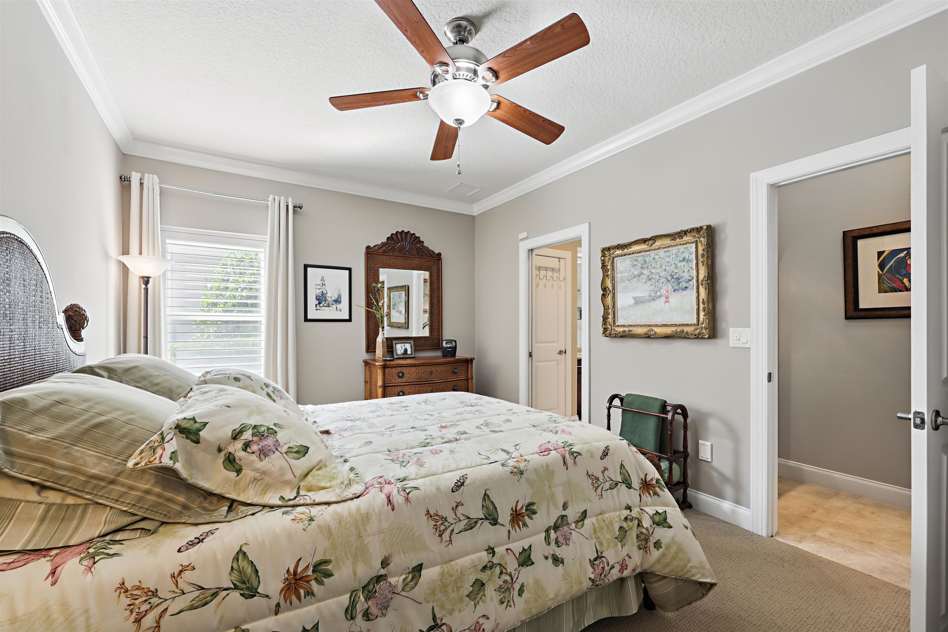 322 Fiddlers Point Drive St. Augustine, FL 32080 - Photo 30 of 58 a bedroom with a large bed and a chandelier