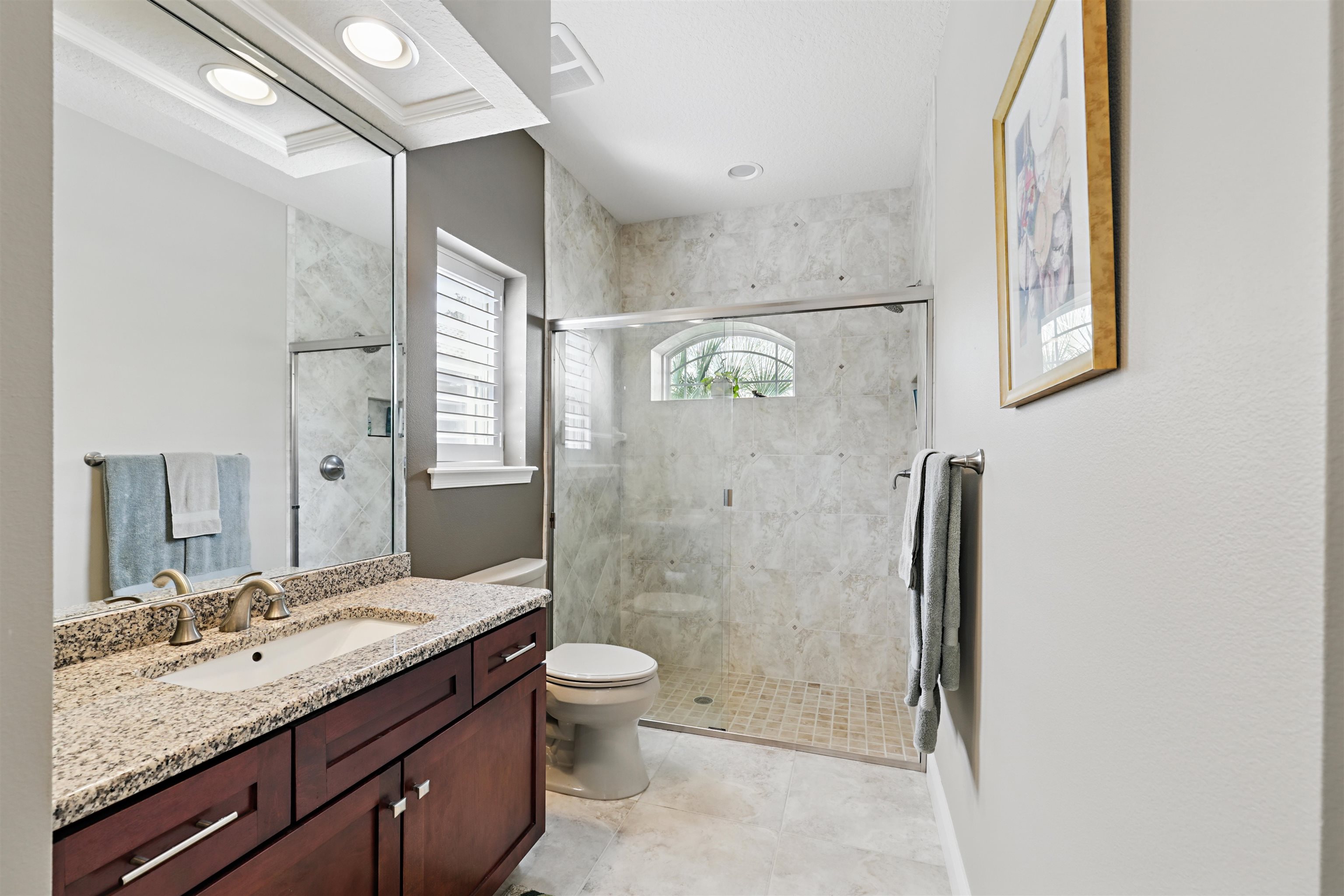 322 Fiddlers Point Drive St. Augustine, FL 32080 - Photo 31 of 58 a bathroom with a granite countertop sink toilet and shower