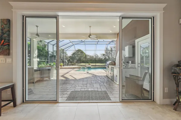 a view of a backyard with swimming pool and furniture