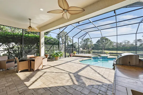 a view of a house with a backyard patio and swimming pool