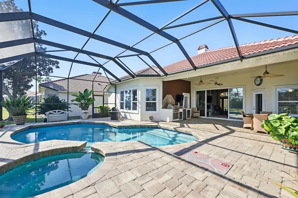 a view of a house with a yard and sitting area