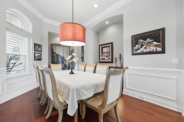 a view of a a dining room with furniture window and wooden floor