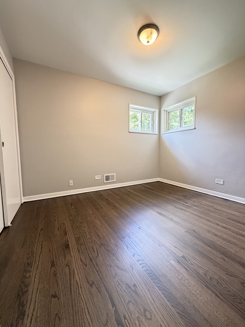 1820 169th Street Hazel Crest, IL 60429 - Photo 16 of 23 an empty room with wooden floor and windows