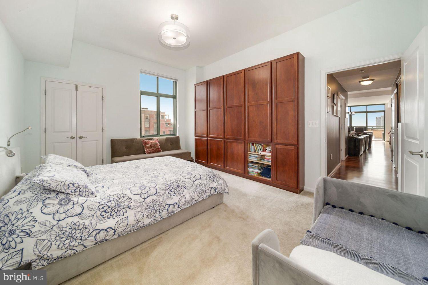 11700 Old Georgetown Road, Unit 1405 North Bethesda, MD 20852 - Photo 11 of 17 a bedroom with a large bed and a couch