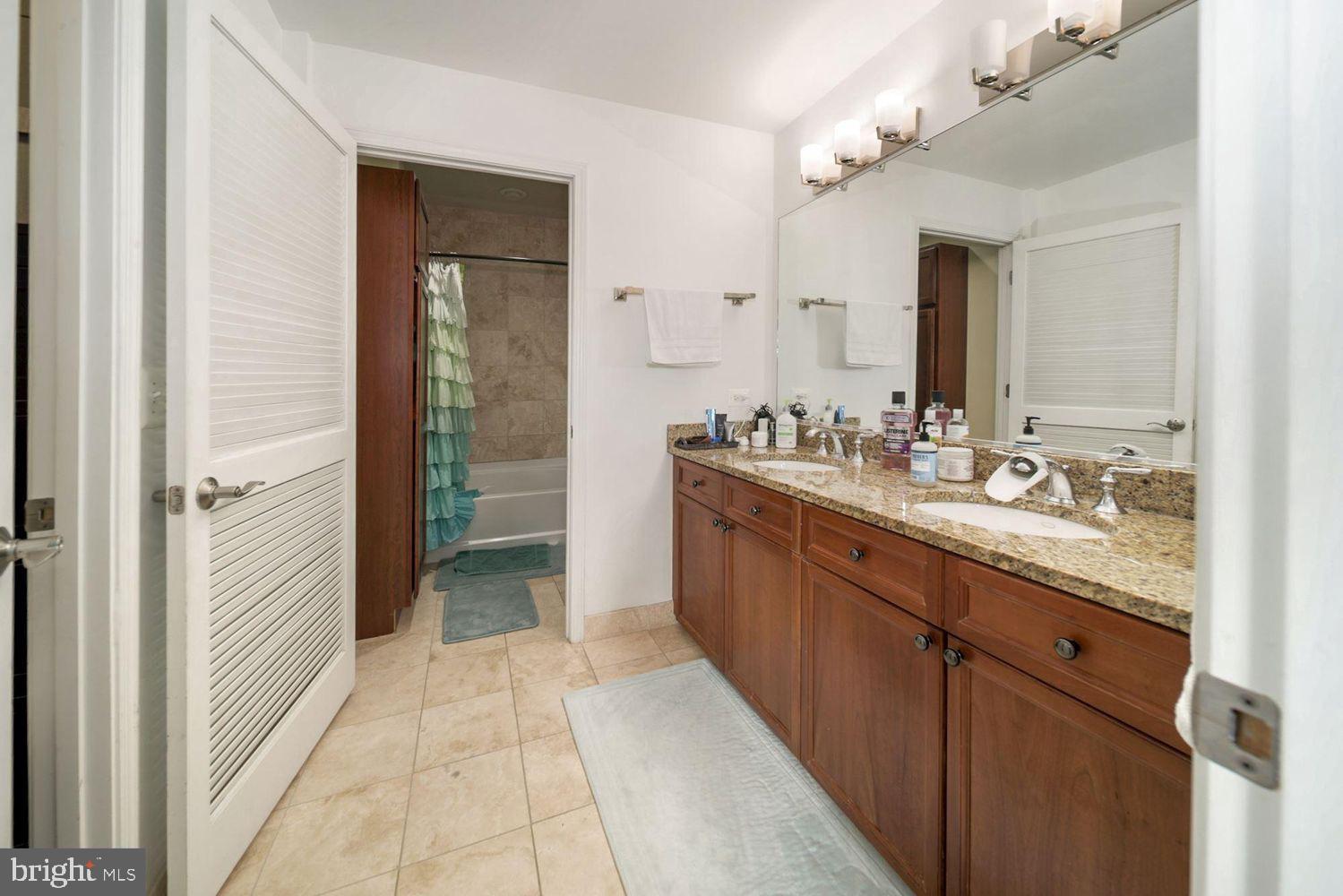 11700 Old Georgetown Road, Unit 1405 North Bethesda, MD 20852 - Photo 14 of 17 a bathroom with a sink a mirror and a shower