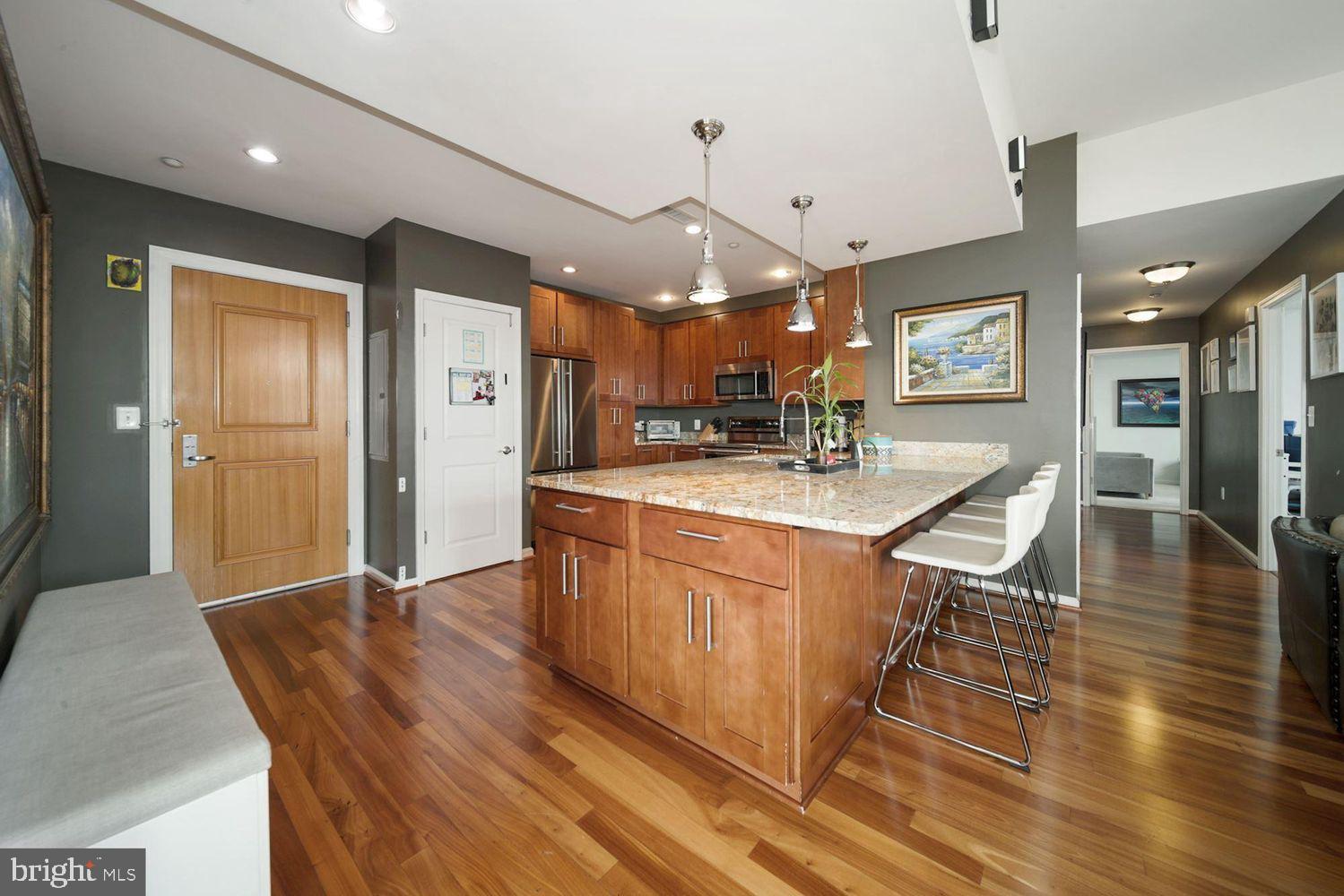 11700 Old Georgetown Road, Unit 1405 North Bethesda, MD 20852 - Photo 3 of 17 a kitchen with stainless steel appliances granite countertop a sink a stove and a refrigerator