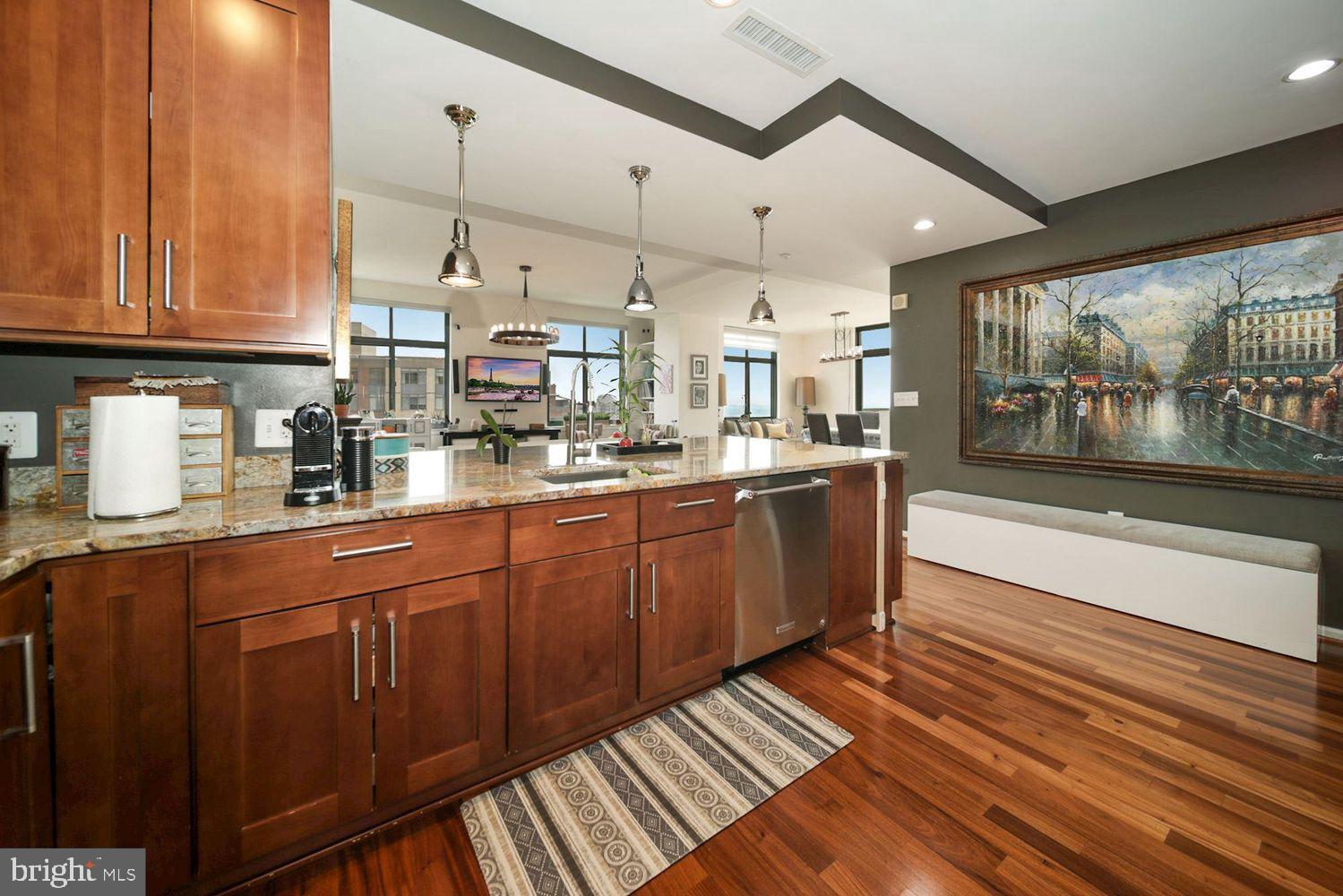 11700 Old Georgetown Road, Unit 1405 North Bethesda, MD 20852 - Photo 4 of 17 a kitchen with stainless steel appliances kitchen island granite countertop a sink and cabinets