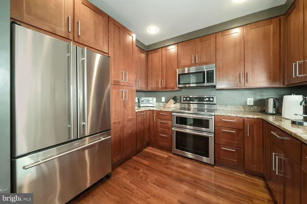 a kitchen with stainless steel appliances a refrigerator sink and microwave