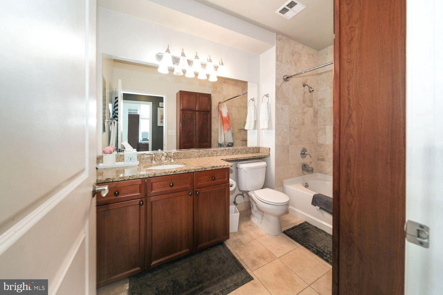 11700 Old Georgetown Road, Unit 1405 North Bethesda, MD 20852 - Photo 10 of 17 a bathroom with a toilet sink and mirror