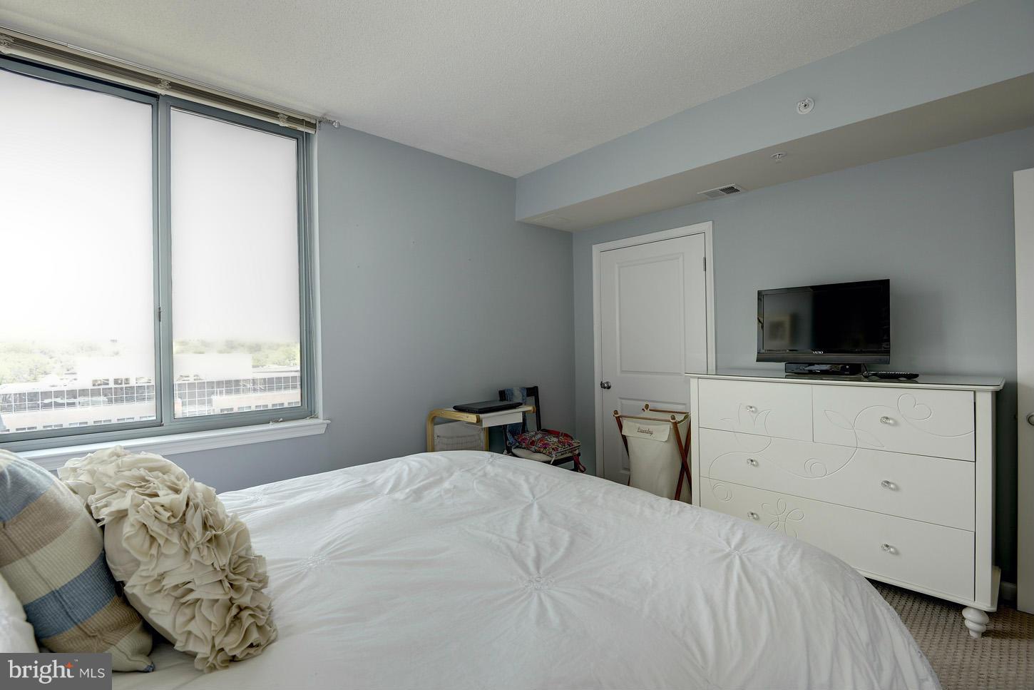 851 North Glebe Road, Unit 1316 Arlington, VA 22203 - Photo 11 of 22 a bedroom with a large bed and a television
