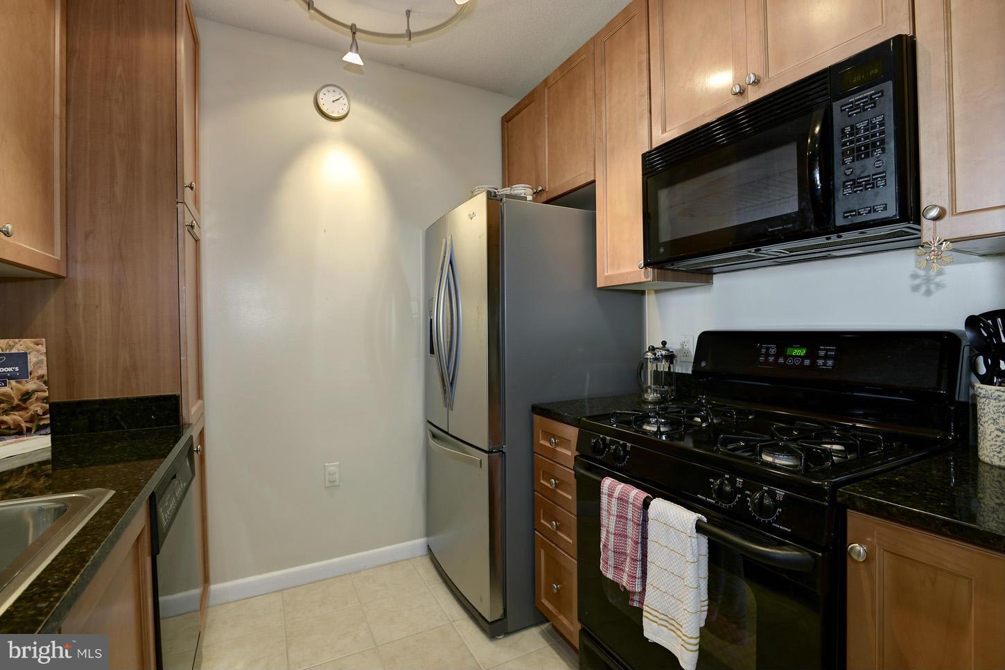 851 North Glebe Road, Unit 1316 Arlington, VA 22203 - Photo 4 of 22 a kitchen with stainless steel appliances a stove a microwave and a sink