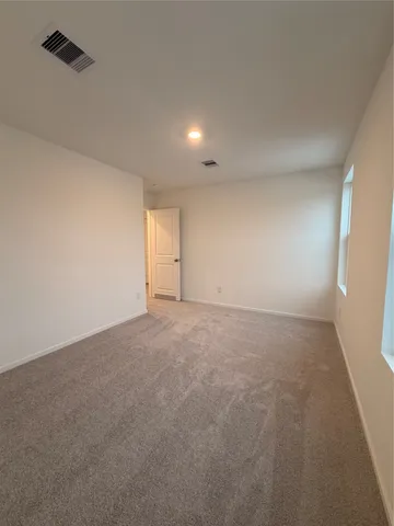 a view of an empty room and a window