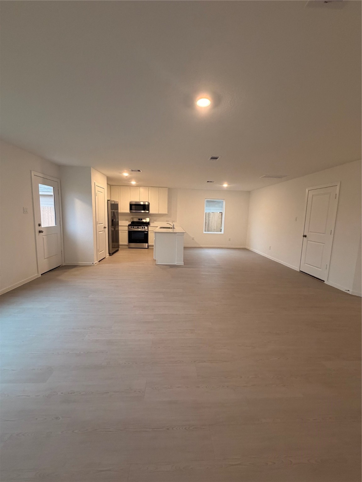 1719 West Stroker Road Crosby, TX 77532 - Photo 3 of 29 a view of an empty room with a fireplace and window