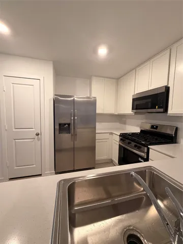 a kitchen with a refrigerator stove and microwave