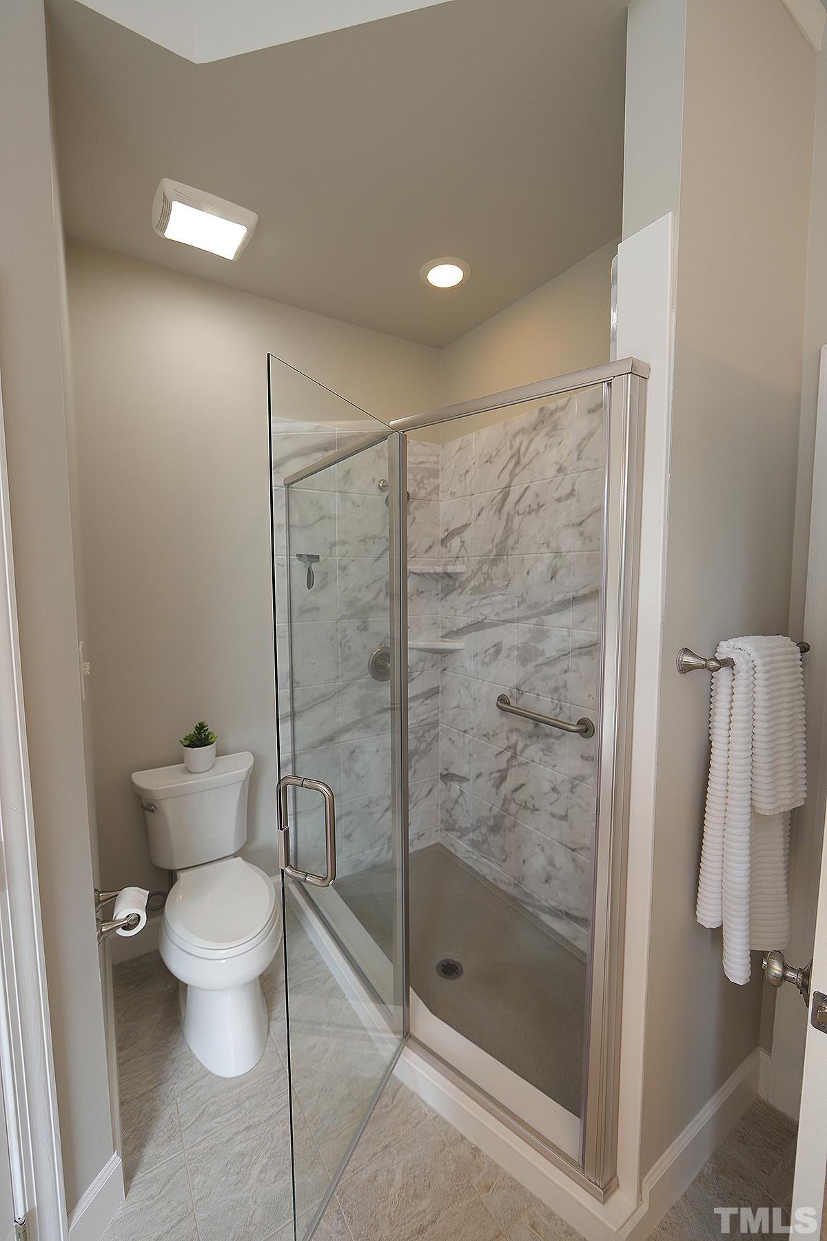 6317 Belle Crest Drive Raleigh, NC 27612 - Photo 15 of 29 a bathroom with a shower and toilet