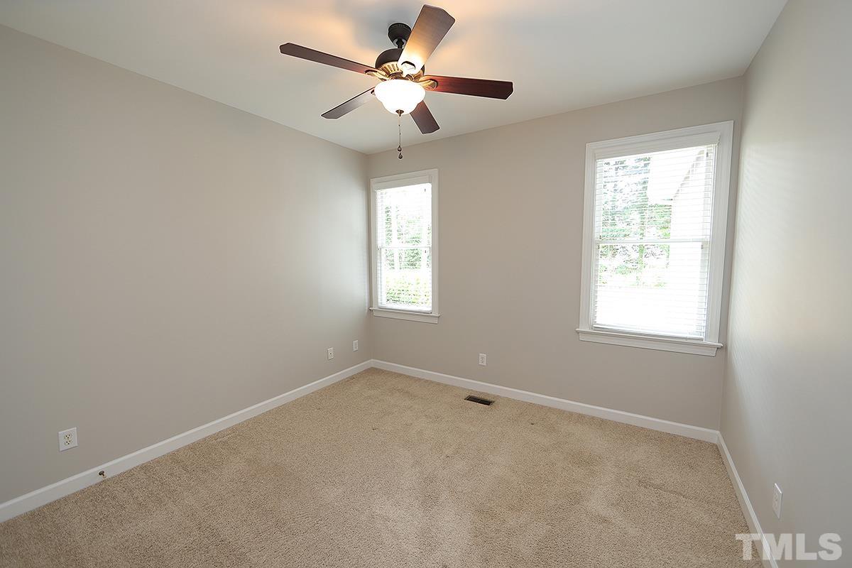 6317 Belle Crest Drive Raleigh, NC 27612 - Photo 17 of 29 an empty room with a window and a fan